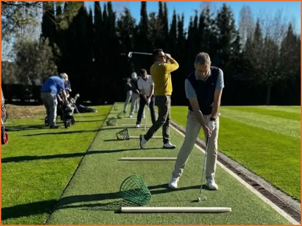 Varios golfistas practicando golpes en el driving range de La Roca Golf