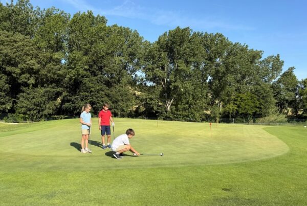Children practising putting on the practice green at La Roca Golf