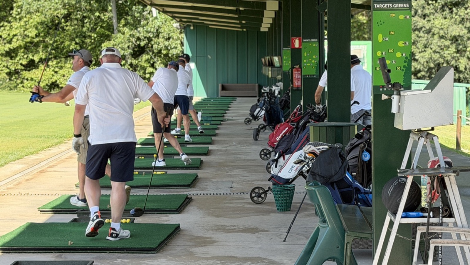Jugadors practicant als llocs coberts del driving range del centre d'entrenament de La Roca Golf.